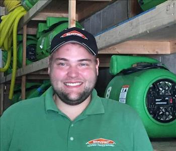 Male SERVPRO Employee standing in front of SERVPRO equipment.