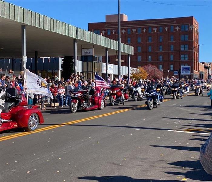 A group of veteran's on motorcycles in veteran's day parade
