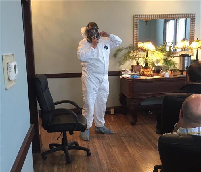 A SERVPRO employee is wearing full personal protective equipment
